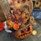 A close up of Wallace's hat. Its orange and brown brocade with a black sash. An arrangement of berries and pumpkins sit on the brim.